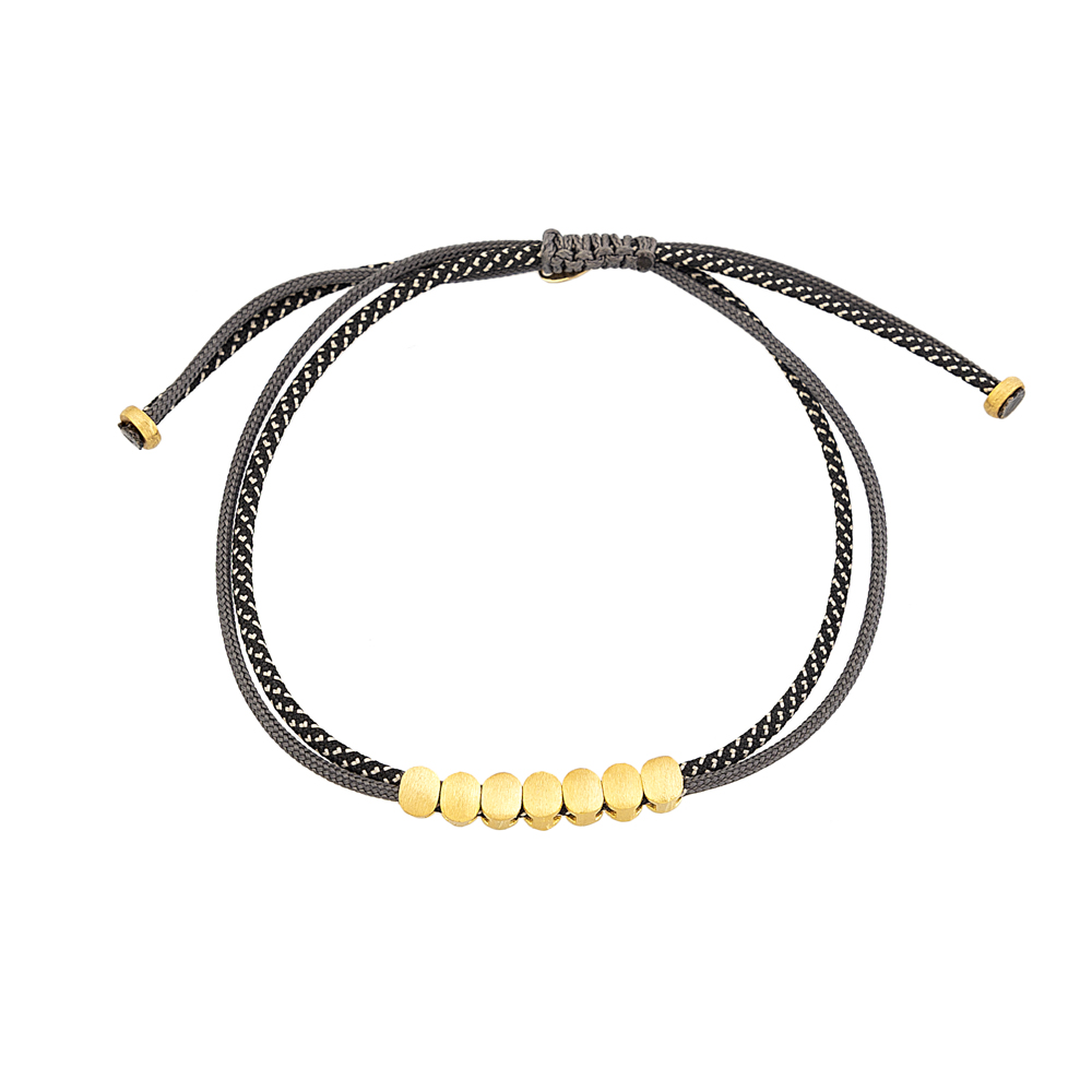 9kt Gold. Seven oval bead bracelet on cord